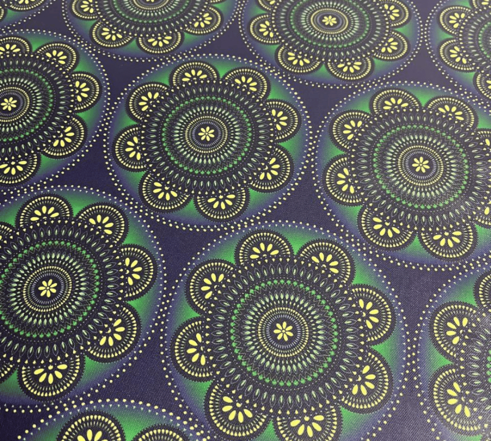 Patterned fabric with green and yellow circles on a dark blue background