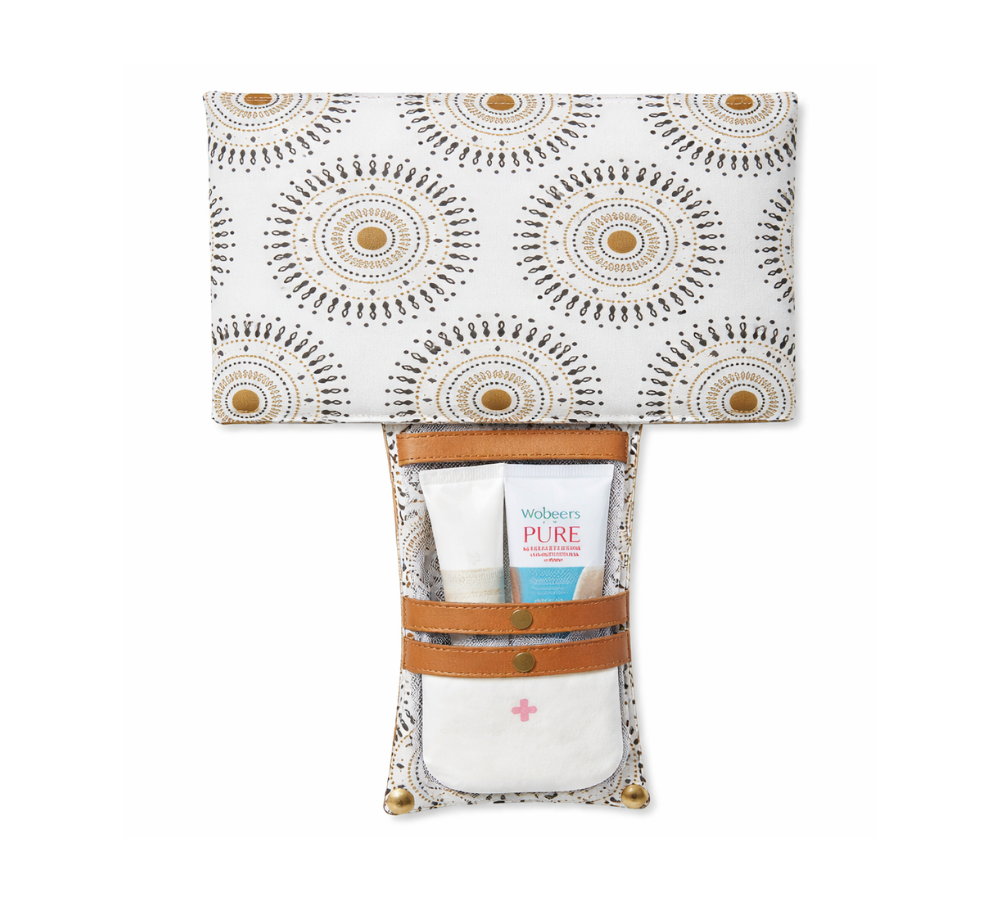 Humba Hides Travel Clutch – An open Portable Nappy Changing Station showing Neutral Shweshwe pattern in waterproof material and genuine leather backing on a white background